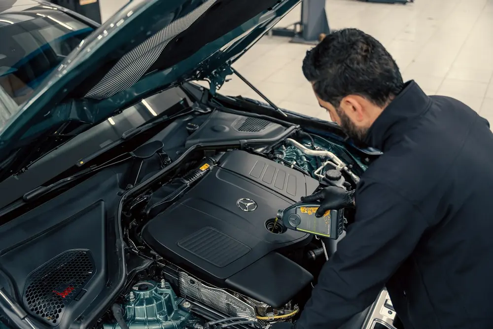 Close-up of hands working in an engine bay